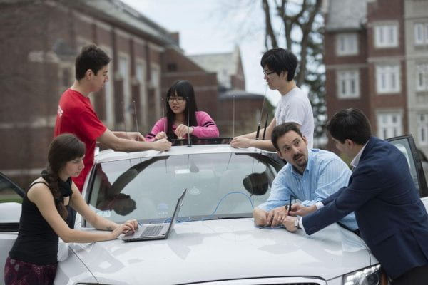 Wyglinski with his undergraduate and graduate students teaching them about connected vehicle technology